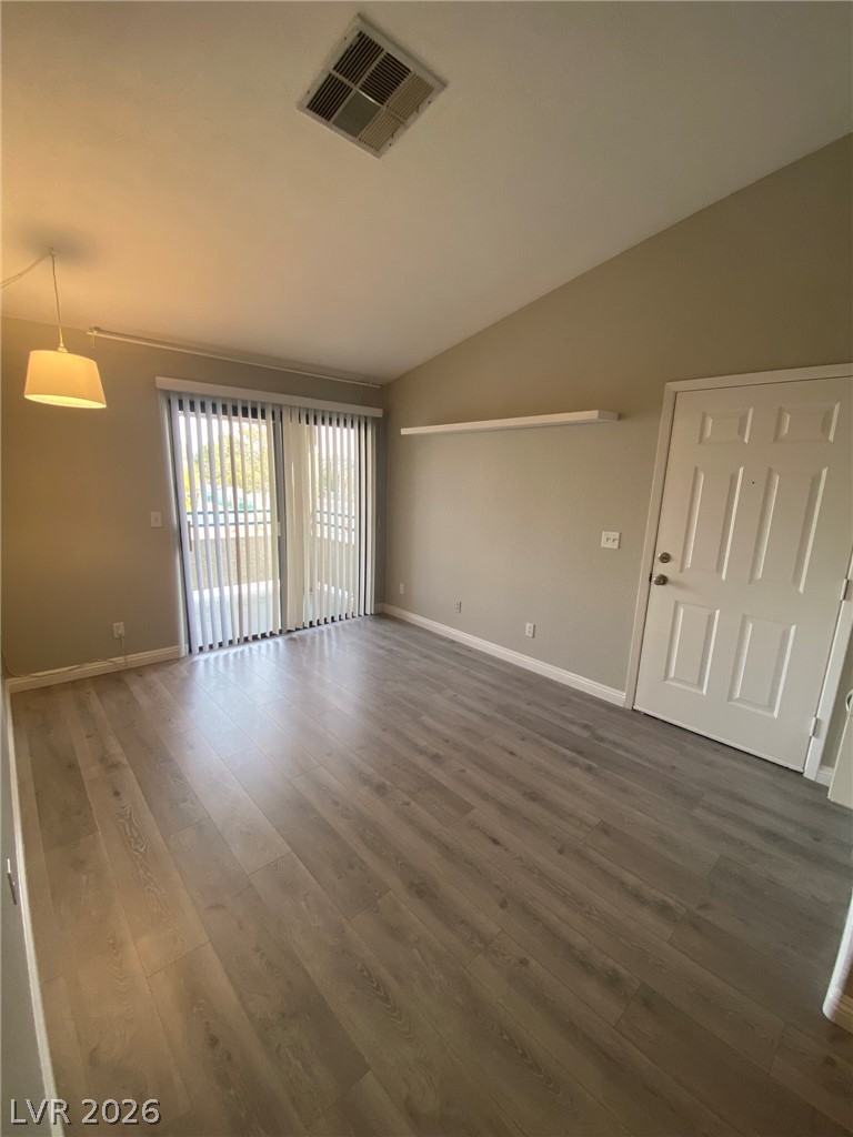 5271 South Lindell Road, Unit 202 Las Vegas, NV 89118 - Photo 6 of 27 Sun-filled living space featuring durable plank flooring and direct outdoor access.