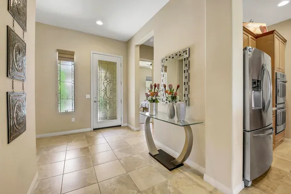a view of a refrigerator in kitchen and livingroom