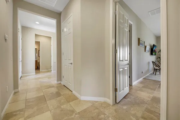 a view of a hallway with closet and bathroom
