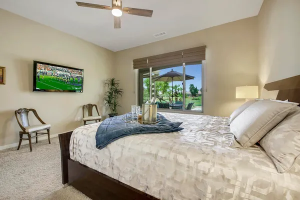 a bedroom with a bed and a flat screen tv