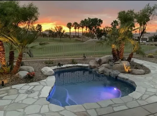 a backyard of a house with table and chairs