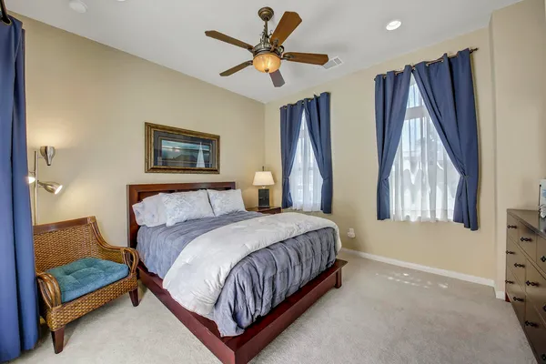 a bedroom with a bed window and a ceiling fan