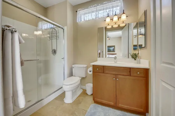 a bathroom with a sink a toilet and shower