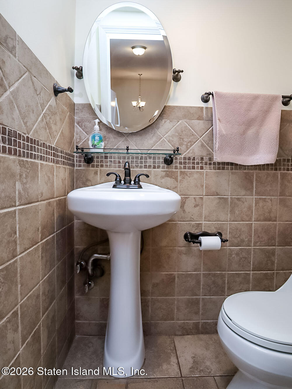 537 Willow Road East, Unit 1 Staten Island, NY 10314 - Photo 11 of 23 a bathroom with a sink toilet and mirror