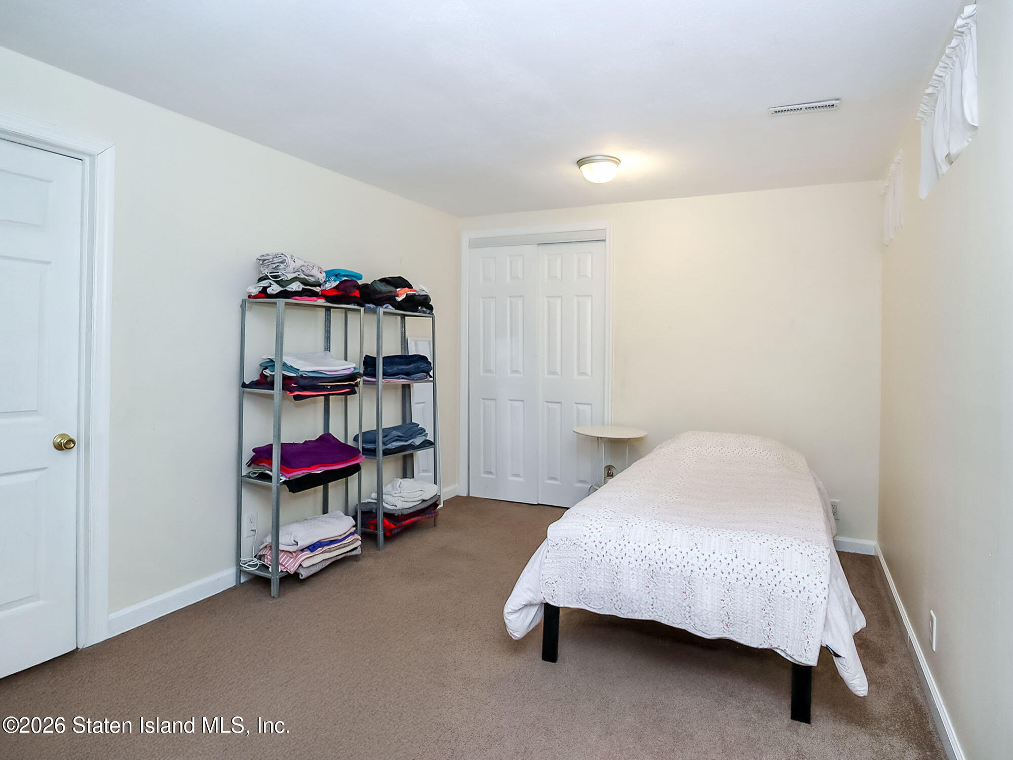 537 Willow Road East, Unit 1 Staten Island, NY 10314 - Photo 16 of 23 a bedroom with a bed and a furniture