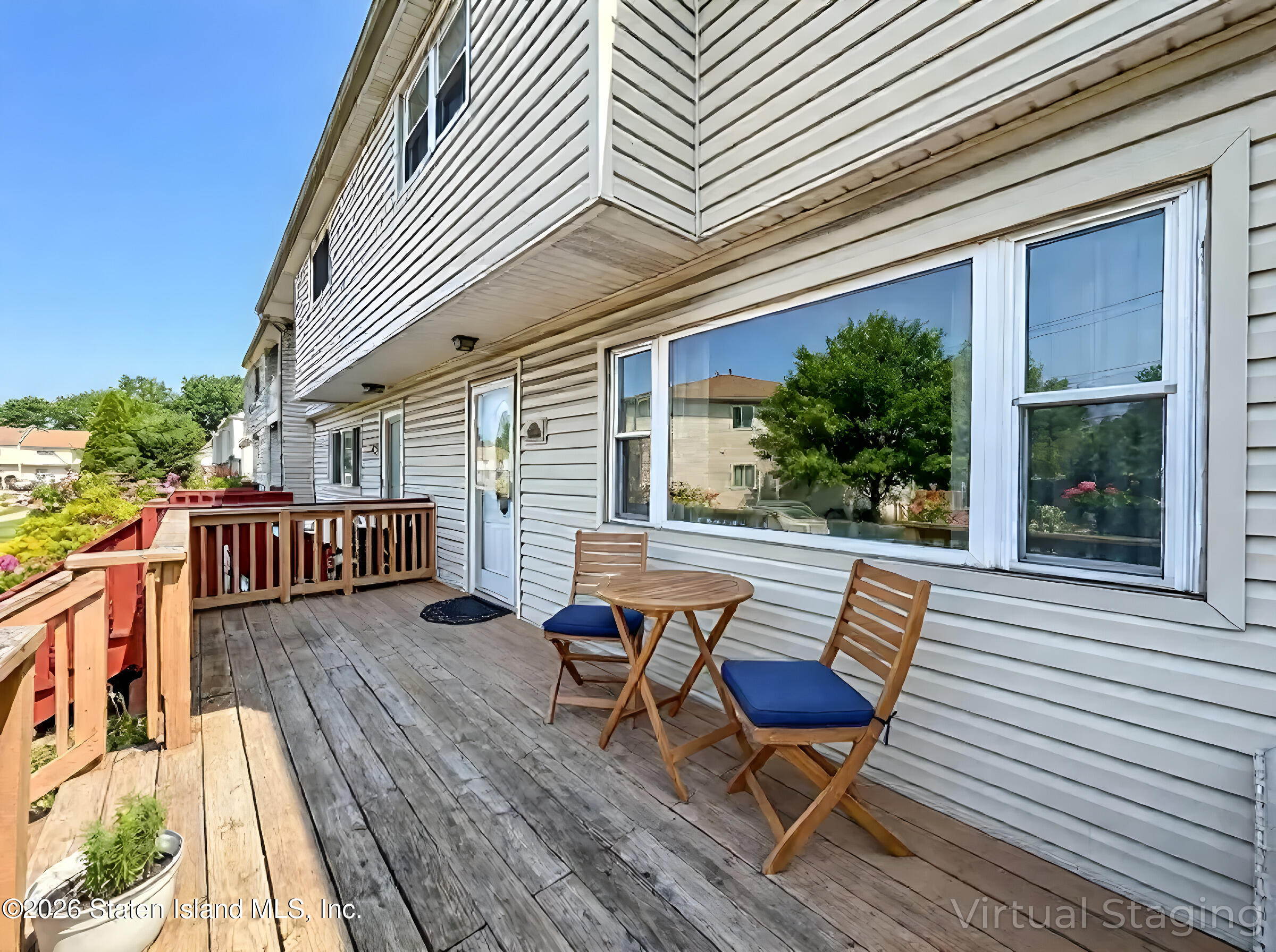 537 Willow Road East, Unit 1 Staten Island, NY 10314 - Photo 4 of 23 a balcony with wooden floor and outdoor seating