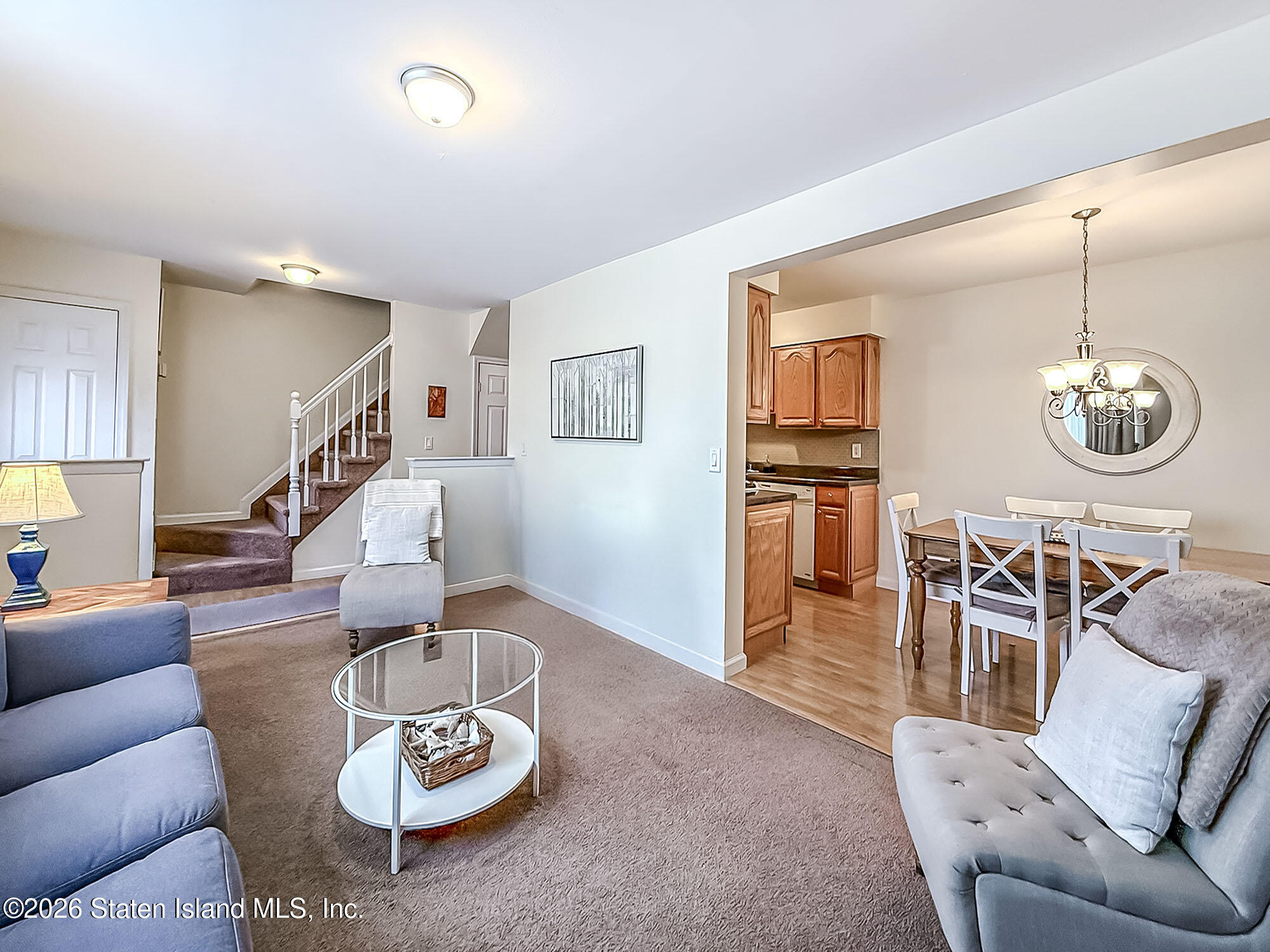 537 Willow Road East, Unit 1 Staten Island, NY 10314 - Photo 6 of 23 a living room with furniture a rug and a chandelier