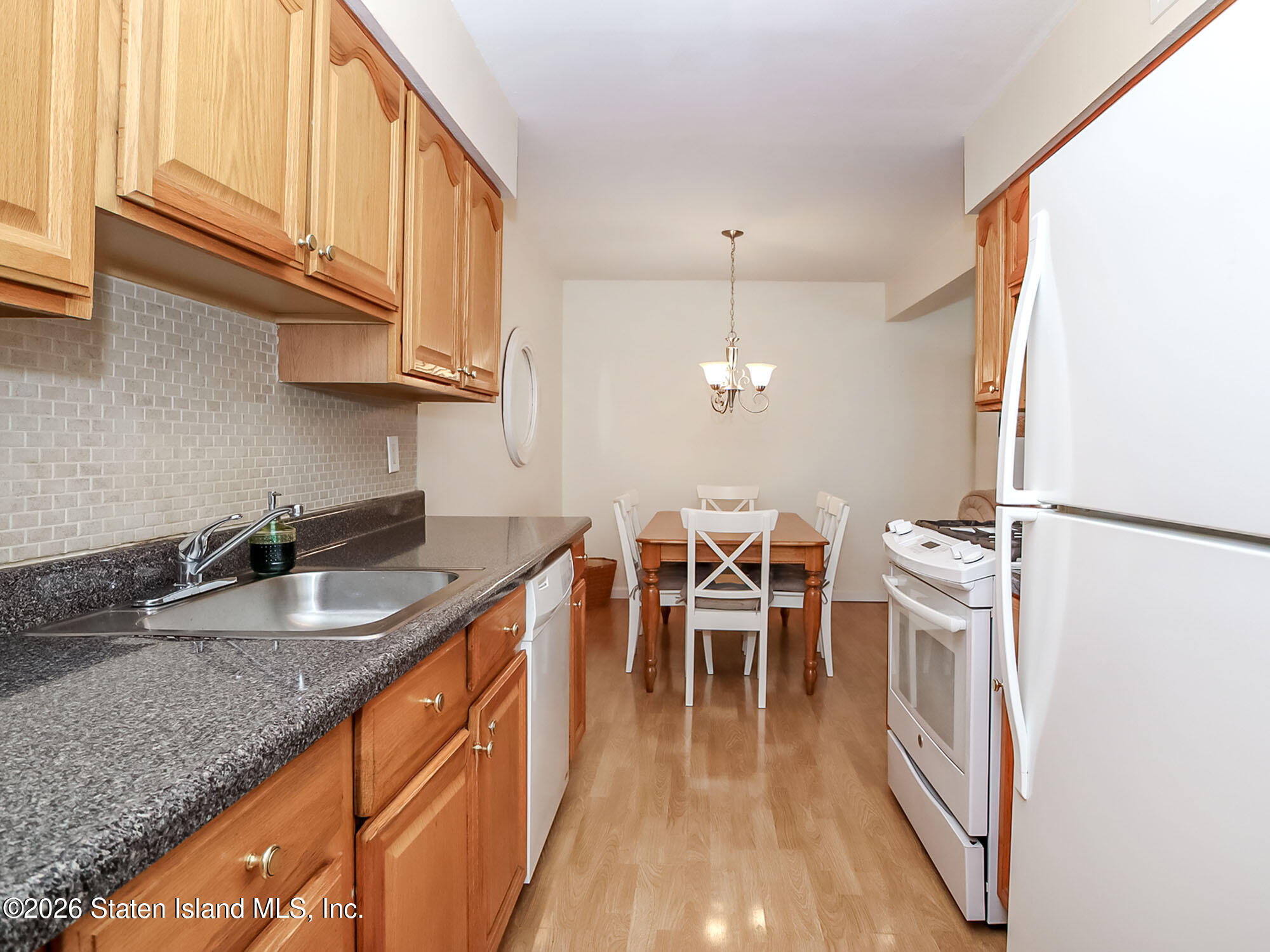 537 Willow Road East, Unit 1 Staten Island, NY 10314 - Photo 9 of 23 a kitchen with granite countertop a sink a counter space appliances and cabinets