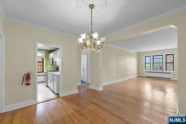 a view of livingroom with chandelier and wooden floor