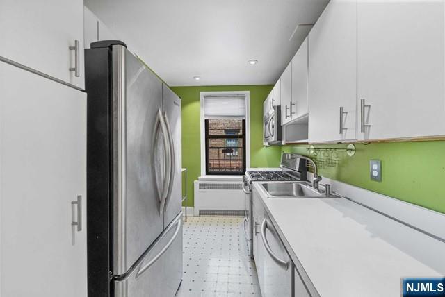 100 Prospect Avenue, Unit 5K Hackensack, NJ 07601 - Photo 3 of 11 a view of a kitchen with a sink and a refrigerator