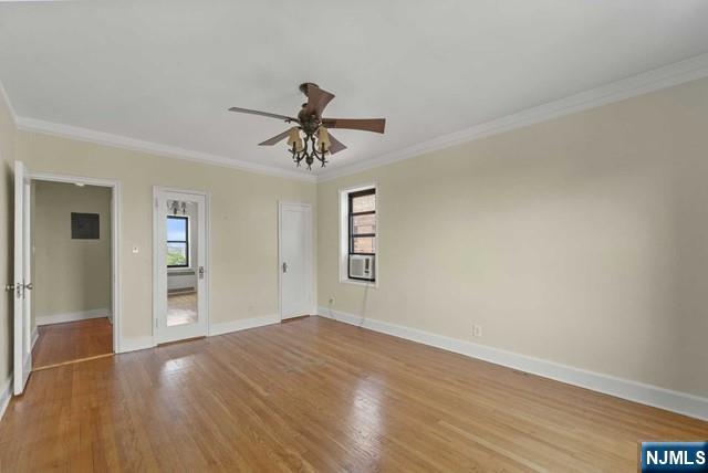 100 Prospect Avenue, Unit 5K Hackensack, NJ 07601 - Photo 8 of 11 a view of empty room with wooden floor and fan