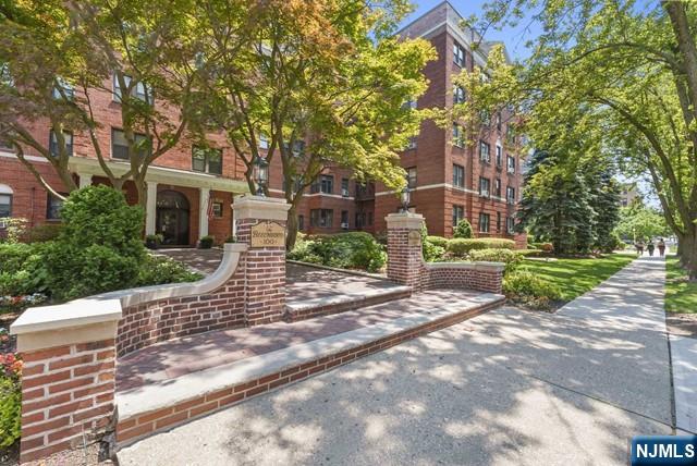 100 Prospect Avenue, Unit 5K Hackensack, NJ 07601 - Photo 10 of 11 a front view of a house with a yard and trees