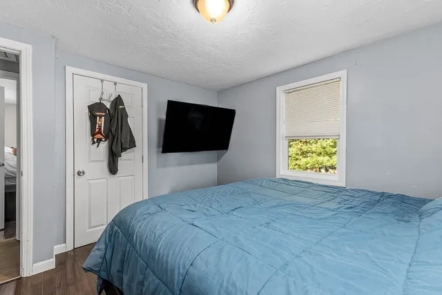 a bedroom with a bed and a television