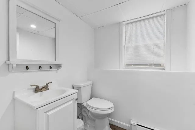 a bathroom with a sink a toilet and mirror