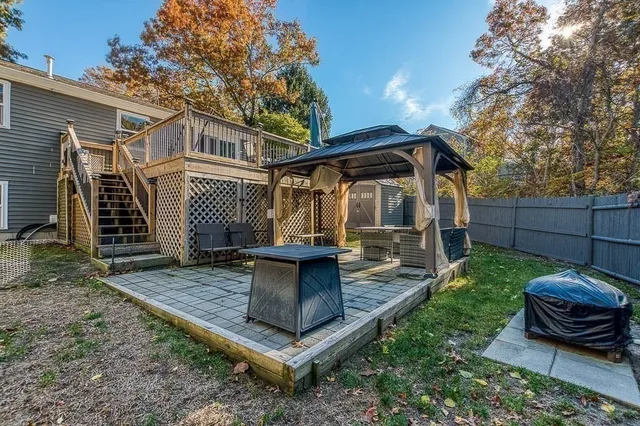a view of a chair and table in backyard