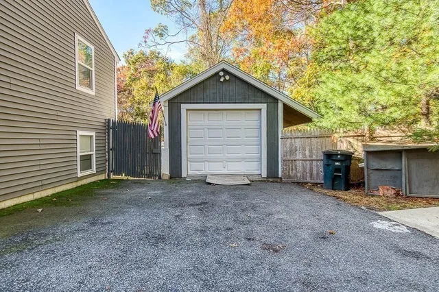 a view of a house with a yard and garage