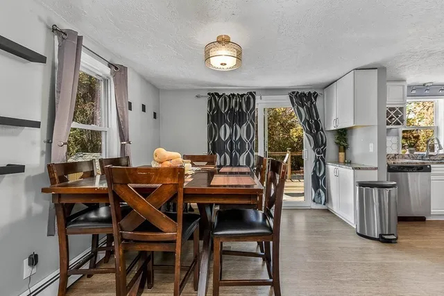 a view of a dining room with furniture and chandelier