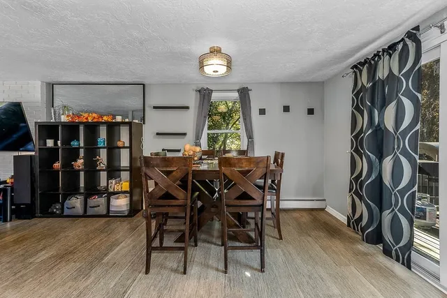 a view of a dining room with furniture and window