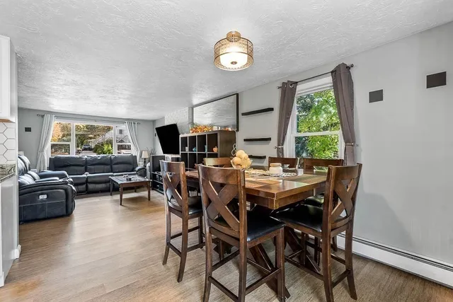 a view of a dining room with furniture and a window