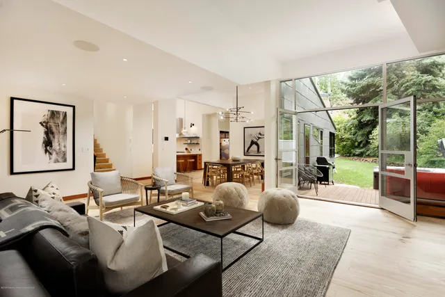 a living room with patio furniture and a large window