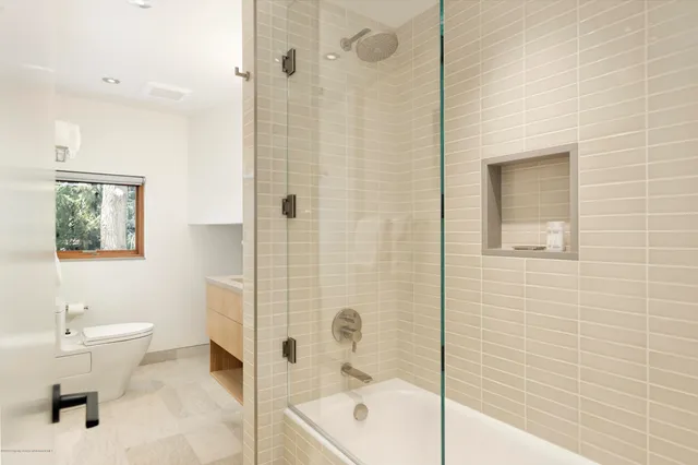 a bathroom with a toilet a sink and shower