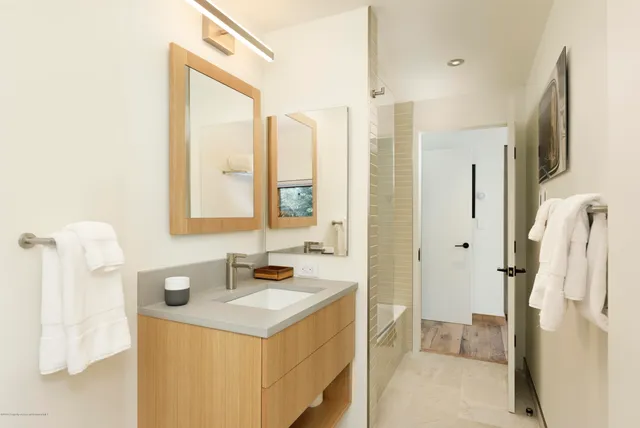 a bathroom with a sink vanity granite tub and shower