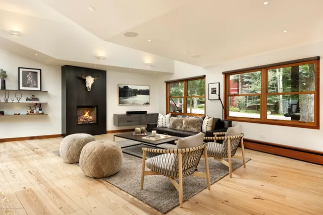 a bedroom with furniture and a large window