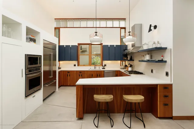 a kitchen with stainless steel appliances a sink and a refrigerator