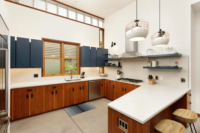 a kitchen with a sink a counter and cabinets