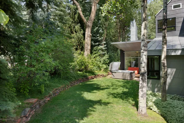 a view of a chair and tables in the backyard of the house