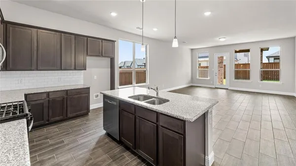 a kitchen with a sink cabinets and wooden floor