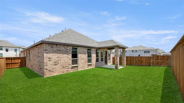 a view of a house with a yard and sitting area