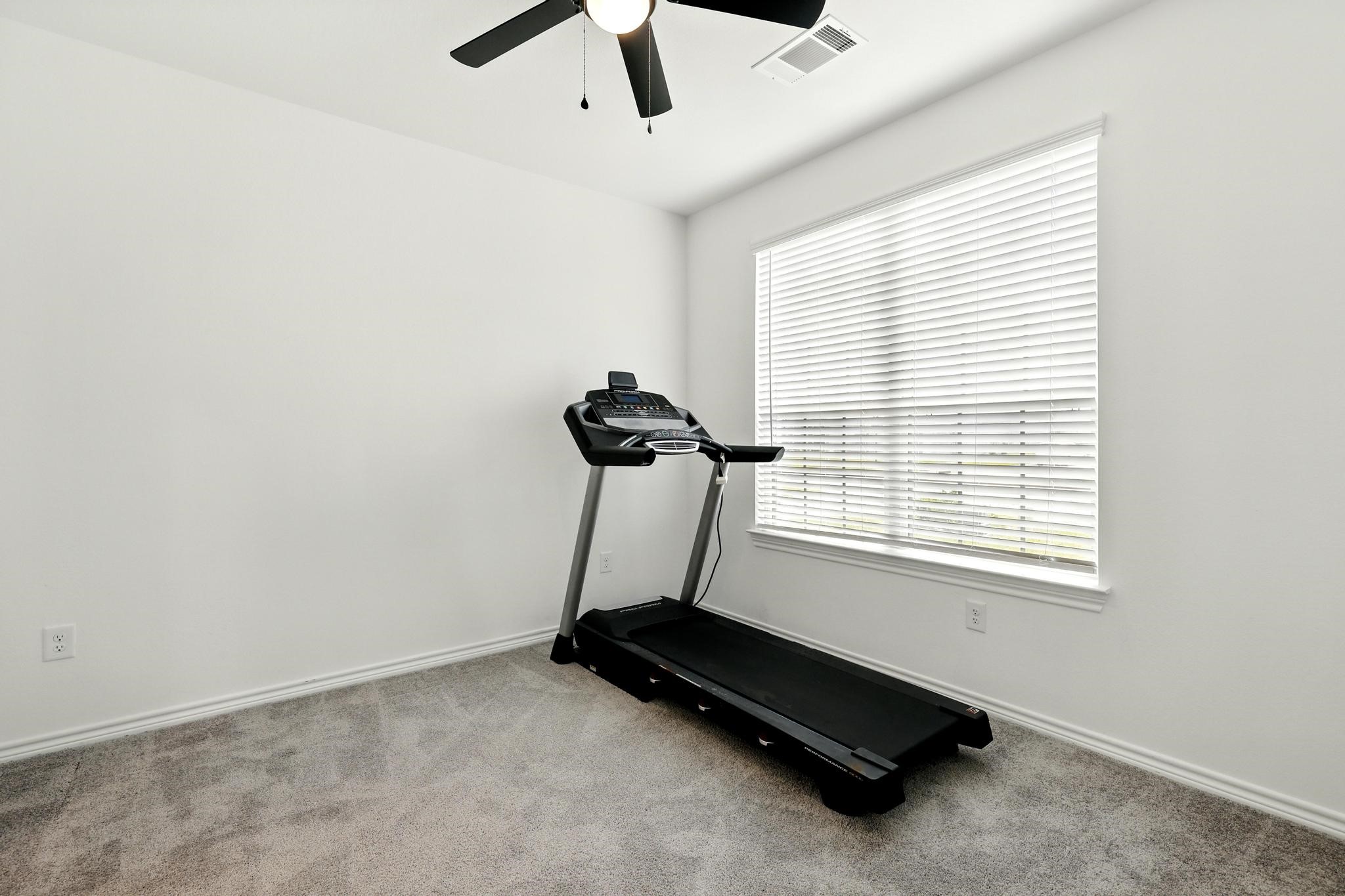 15727 Rosemary Hl Lane Conroe, TX 77302 - Photo 14 of 28 a room with gym equipment and windows