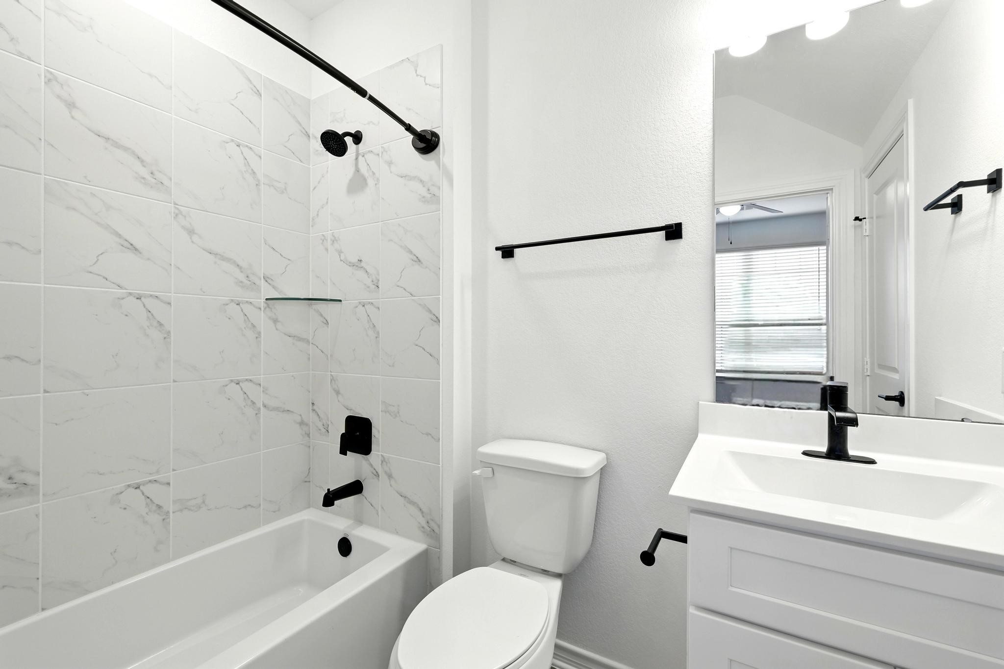 15727 Rosemary Hl Lane Conroe, TX 77302 - Photo 16 of 28 a bathroom with a sink a toilet and a bathtub