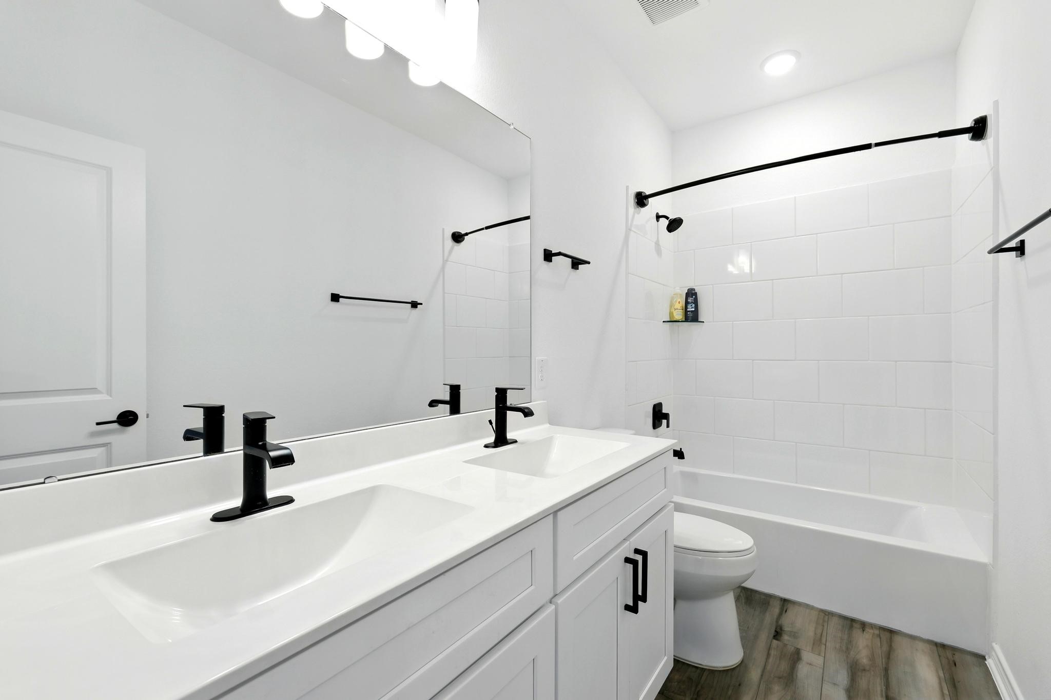 15727 Rosemary Hl Lane Conroe, TX 77302 - Photo 22 of 28 a bathroom with a sink a toilet and a mirror