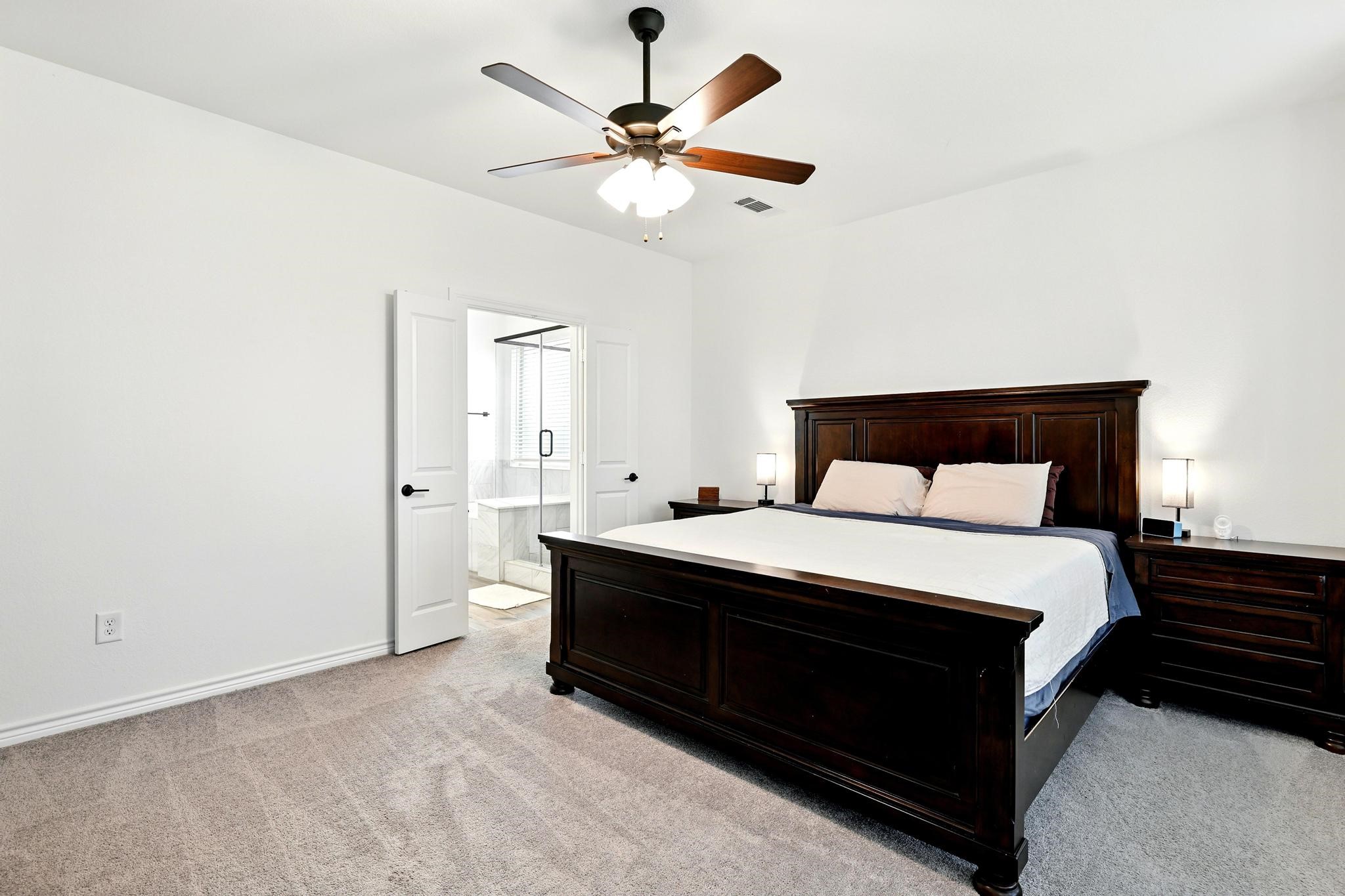 15727 Rosemary Hl Lane Conroe, TX 77302 - Photo 8 of 28 a bedroom with a bed and window