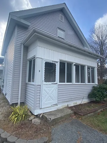 a view of room with hardwood floor and a window