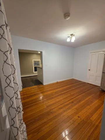 a kitchen with granite countertop white cabinets and black appliances