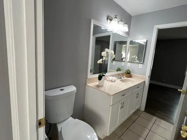 a bathroom with a toilet sink and mirror