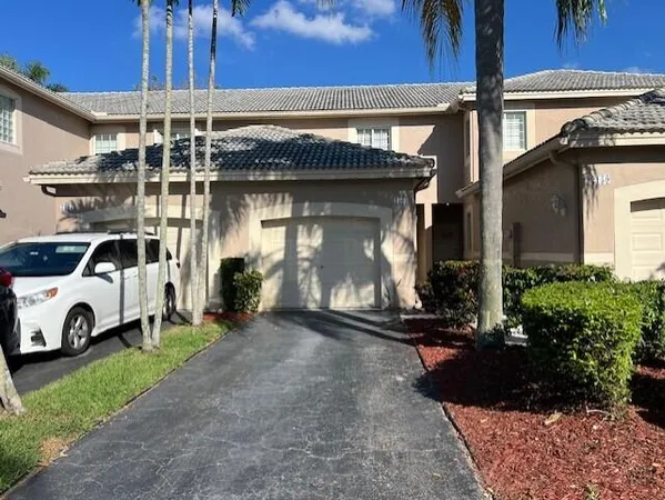 a view of a car park in front of house