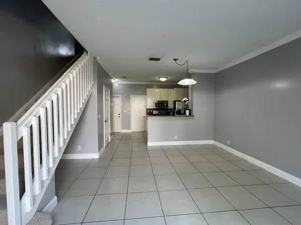 a view of a livingroom with furniture and an empty room