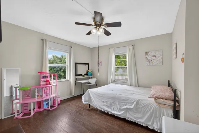 a bedroom with a bed a chandelier and a window