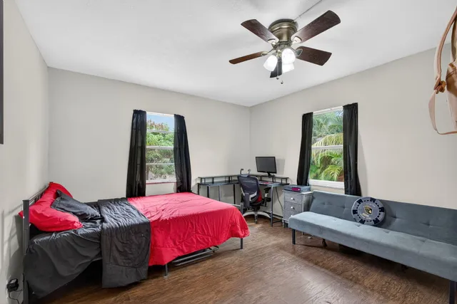 a bedroom with a bed and a large window