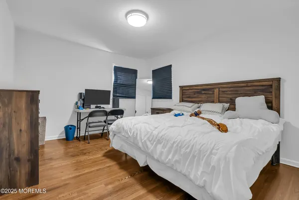 a bedroom with bed and a desk