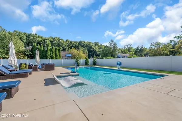 a view of backyard with seating area and green space