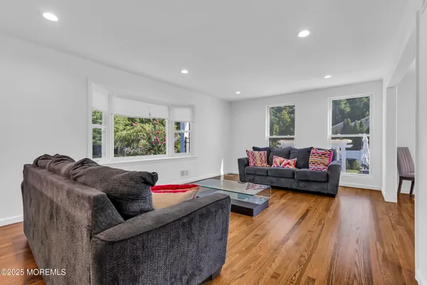 a living room with furniture window and wooden floor