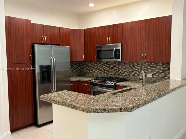 an empty room with kitchen view and appliances