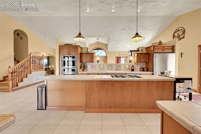 a living room with furniture a chandelier and a large window