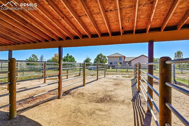 a view of a patio with a table and chairs