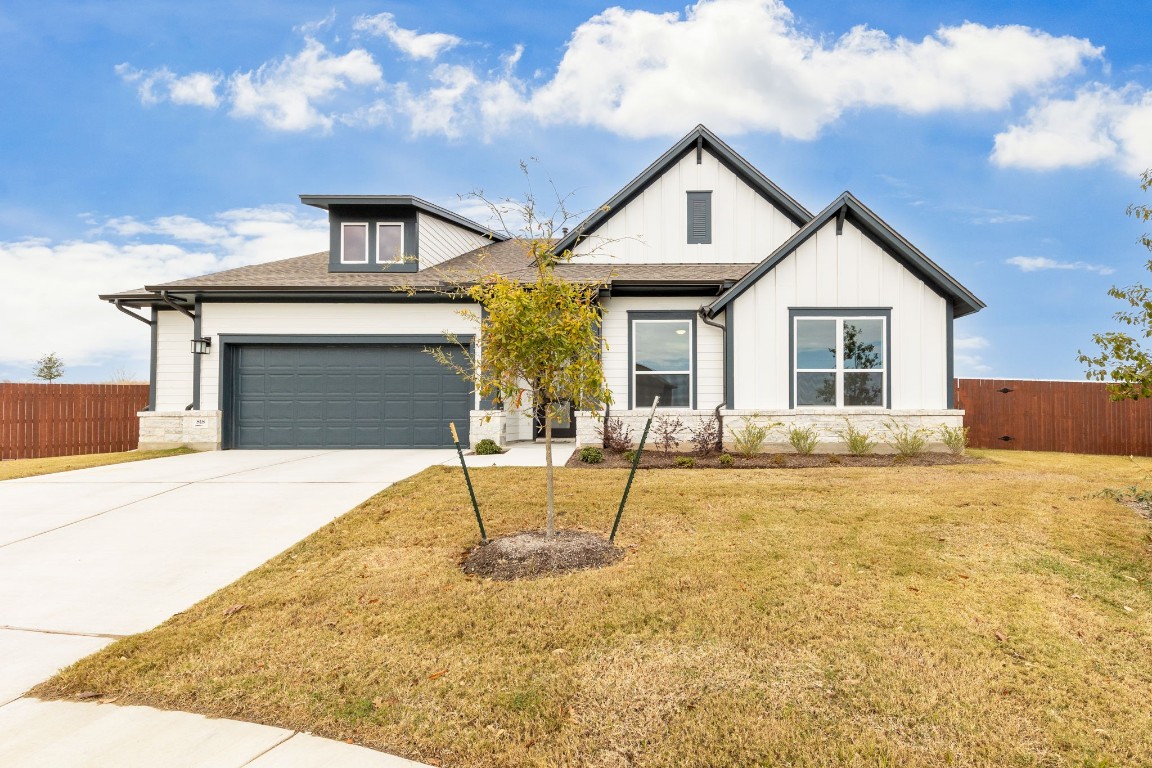 a front view of a house with a yard and garage
